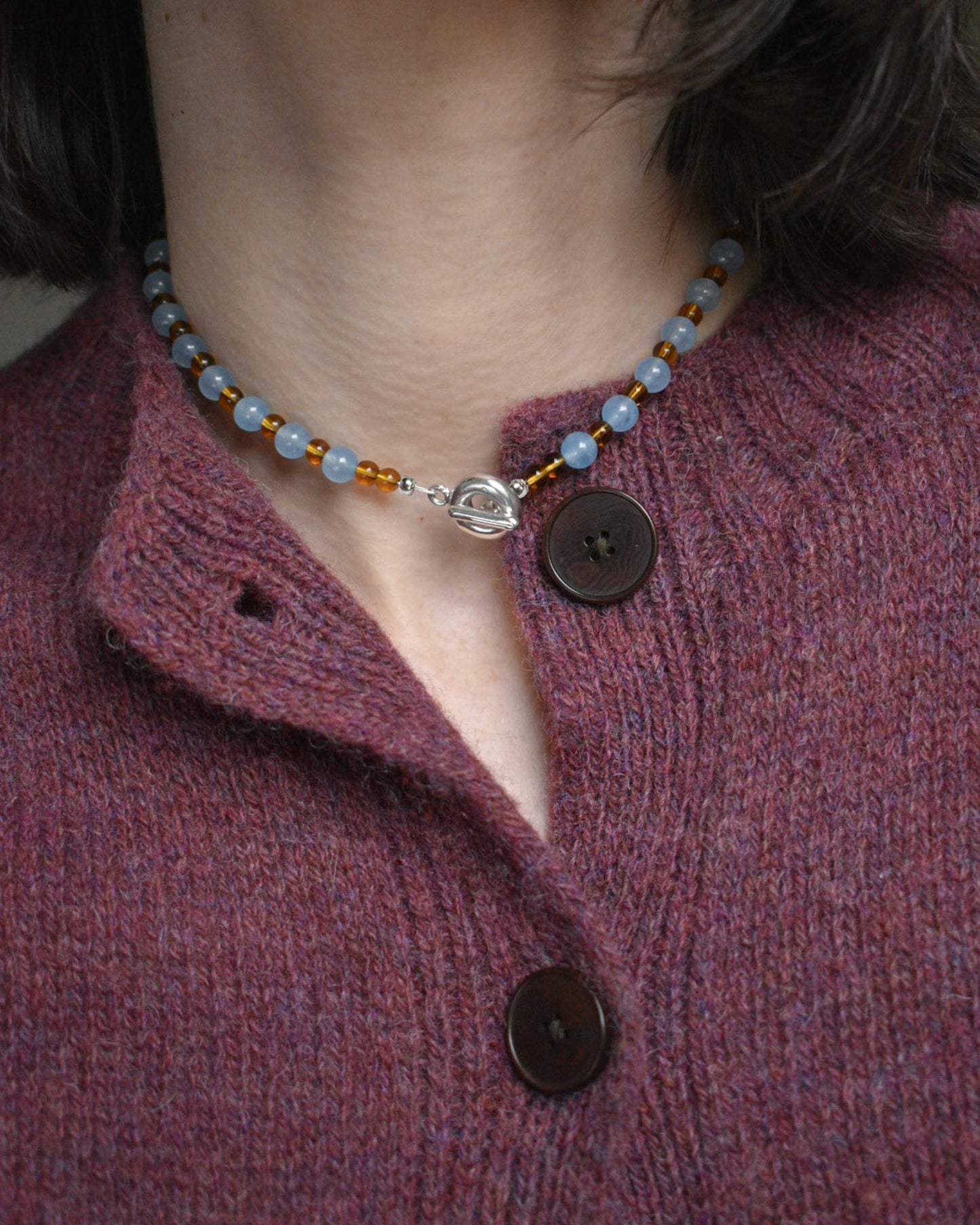 colourful beaded necklace in brown glass beads and baby blue jade semi precious stones. finished with hand carved solid recycled silver doughnut clasps.