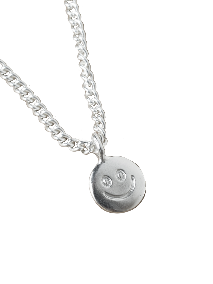 smiley hand carved doodle on a silver shiny disk pendant