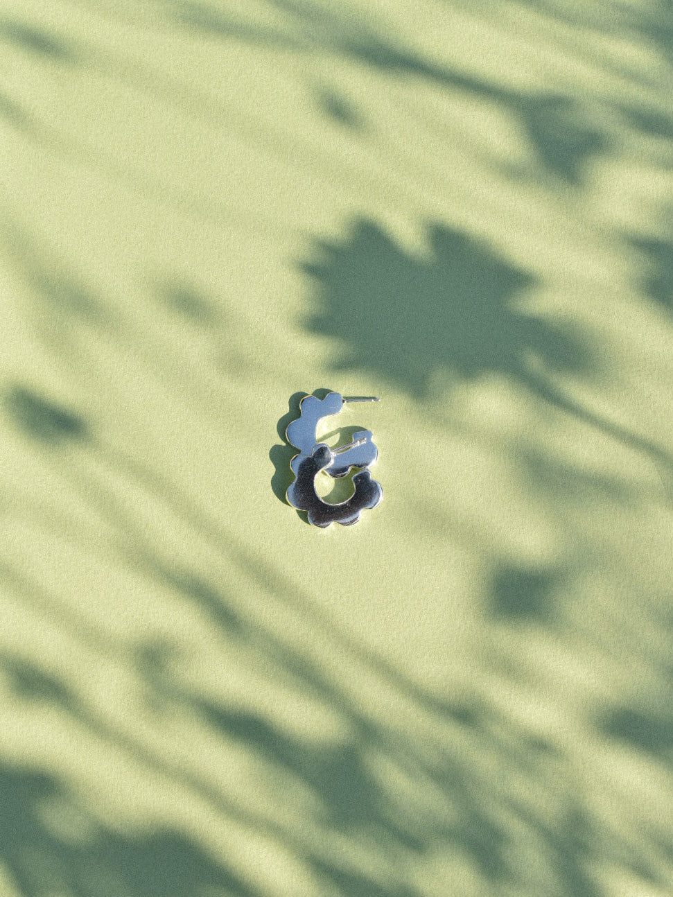 fun playful scallop flower shaped hoop earrings in solid recycled shiny silver with push backs.