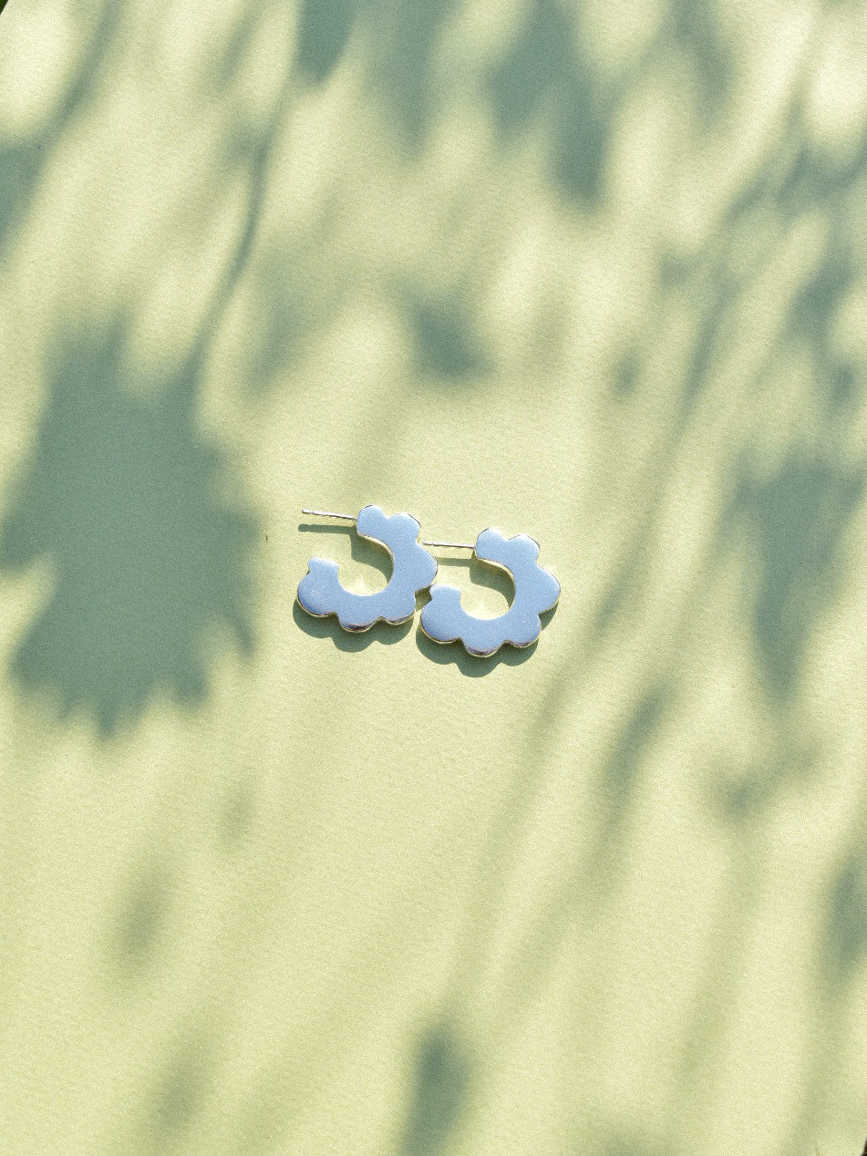 fun playful scallop flower shaped hoop earrings in solid recycled shiny silver with push backs.