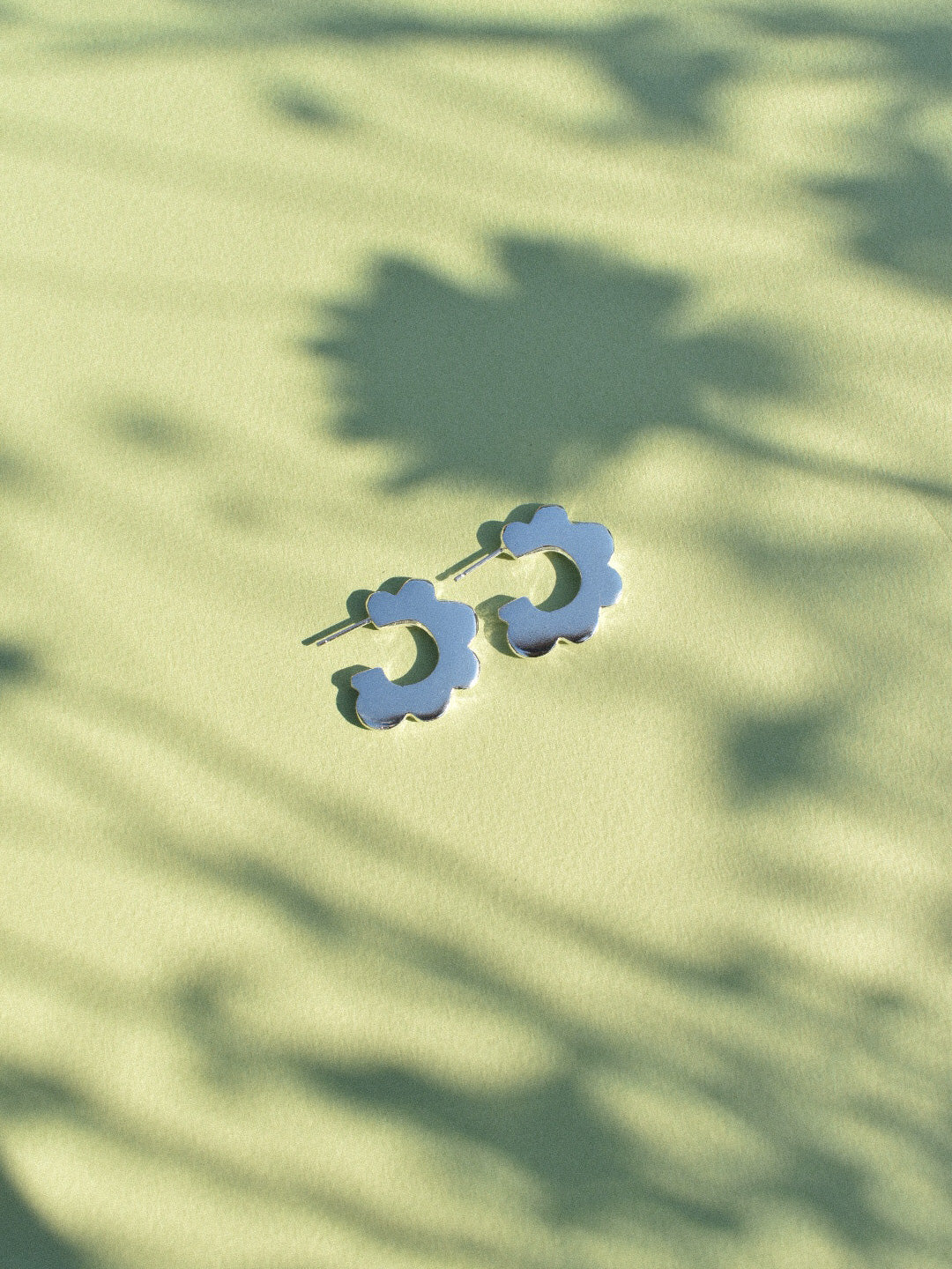 fun playful scallop flower shaped hoop earrings in solid recycled shiny silver with push backs.