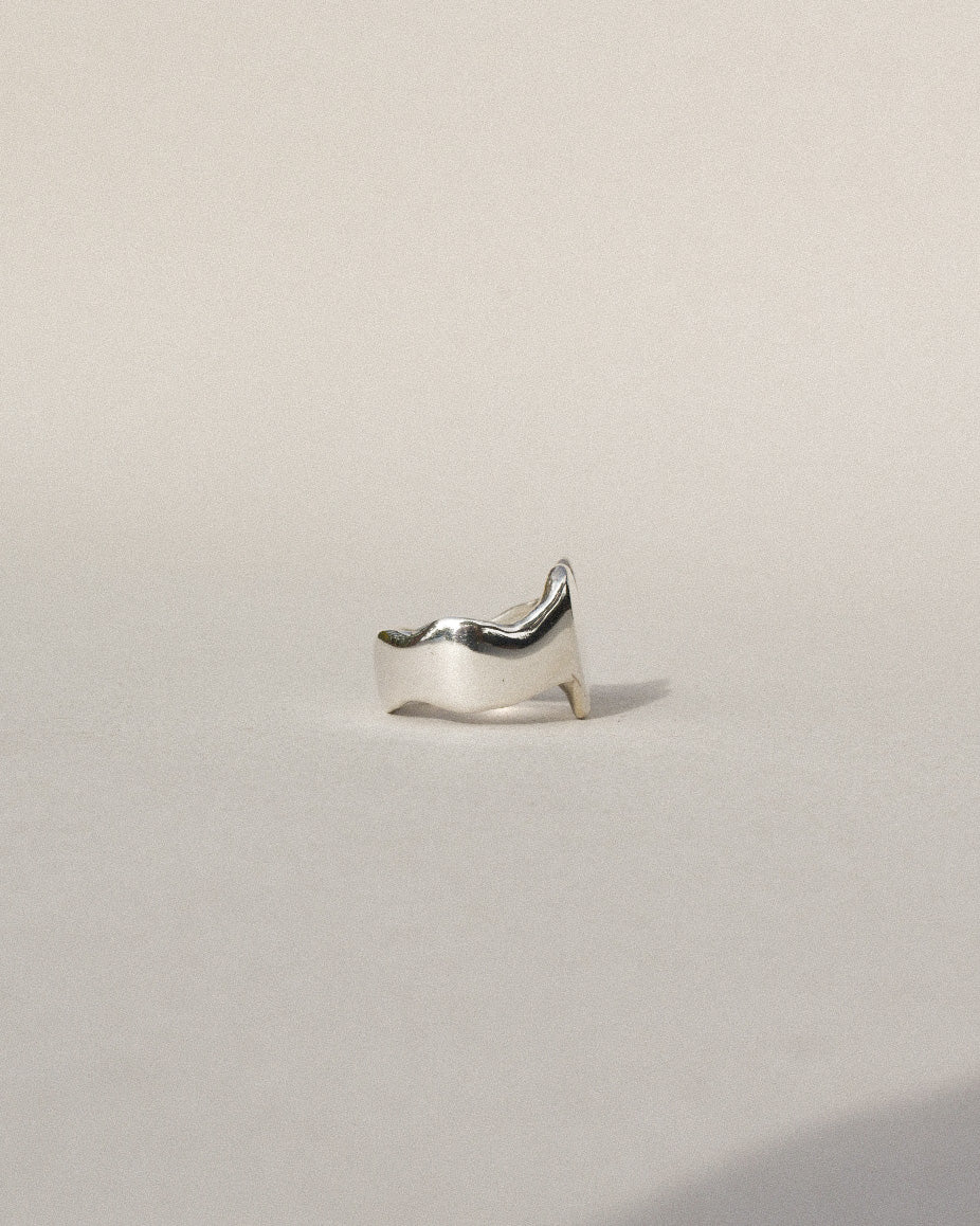 hand carved heart shaped signet ring with waved band and organic wobbly shape. shiny solid recycled silver. eco metal.