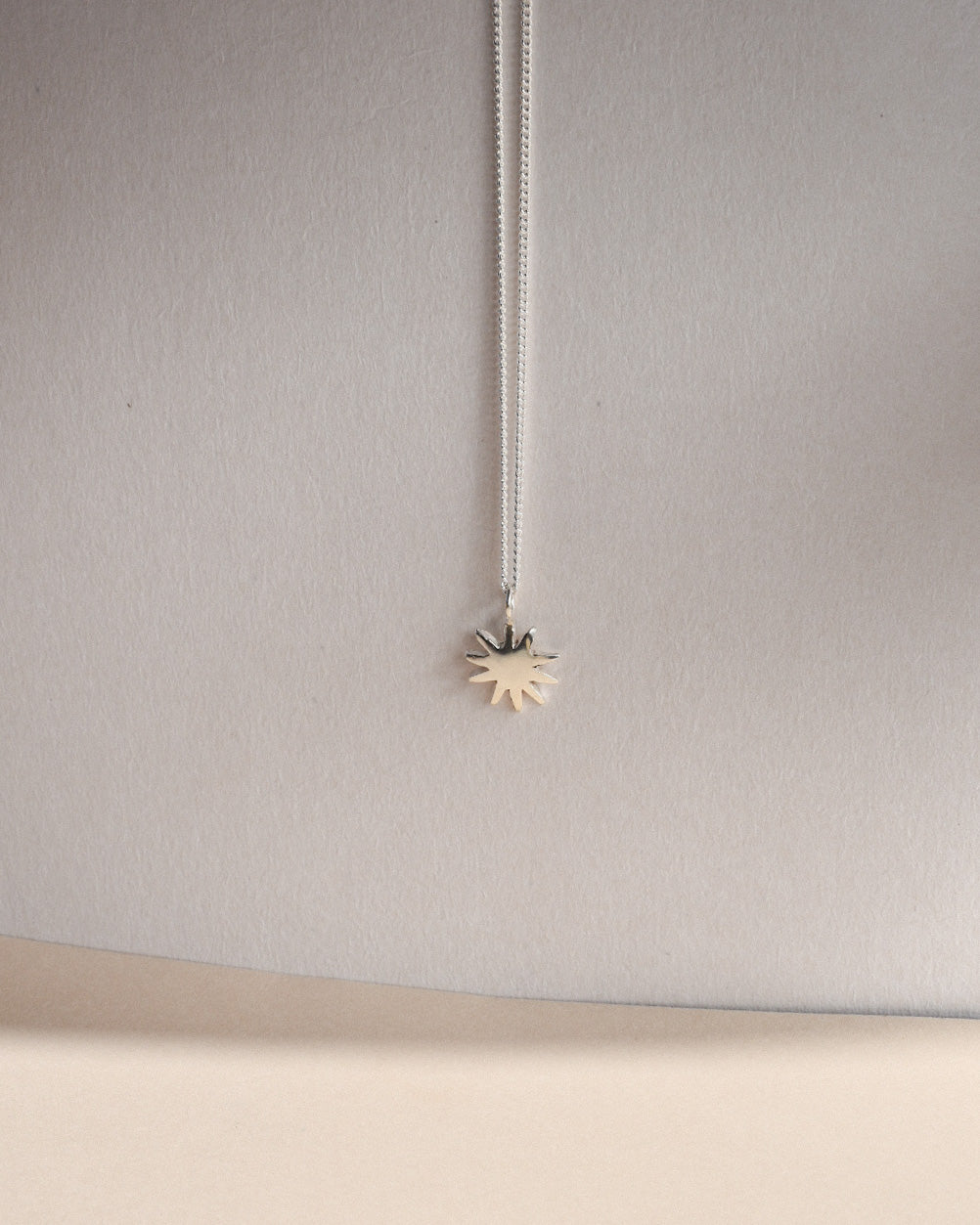 dahlia star shaped solid eco recycled silver pendant on a slim silver chain necklace