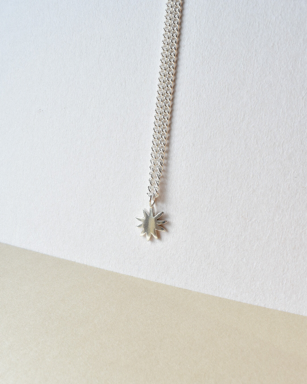 dahlia star shaped solid eco recycled silver pendant on a slim silver chain necklace