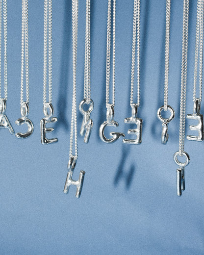 recycled silver hand moulded wobbly alphabet initial charms with organic texture