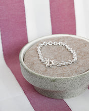 Load image into Gallery viewer, a cushioned dish holds a solid recycled silver heavy quality chain bracelet with hand carved star shaped toggle clasp
