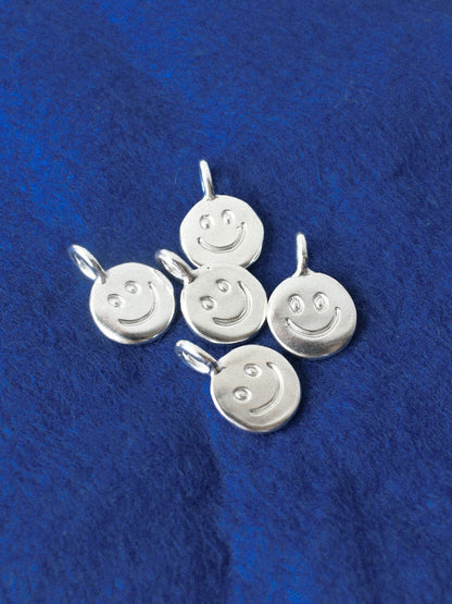 smiley hand carved doodle on a silver shiny disk pendant 