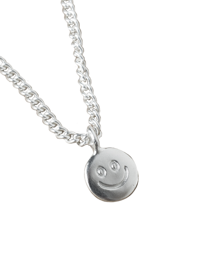 smiley hand carved doodle on a silver shiny disk pendant 