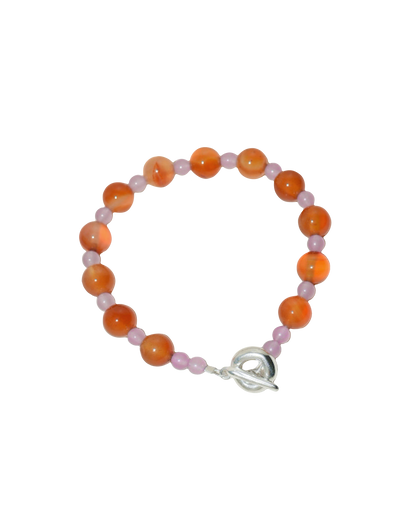 beaded bracelet made of colourful stones and solid recycled silver doughnut toggle clasp. the bracelet is orange and lilac purple with carnelian and lilac dyed jade.
