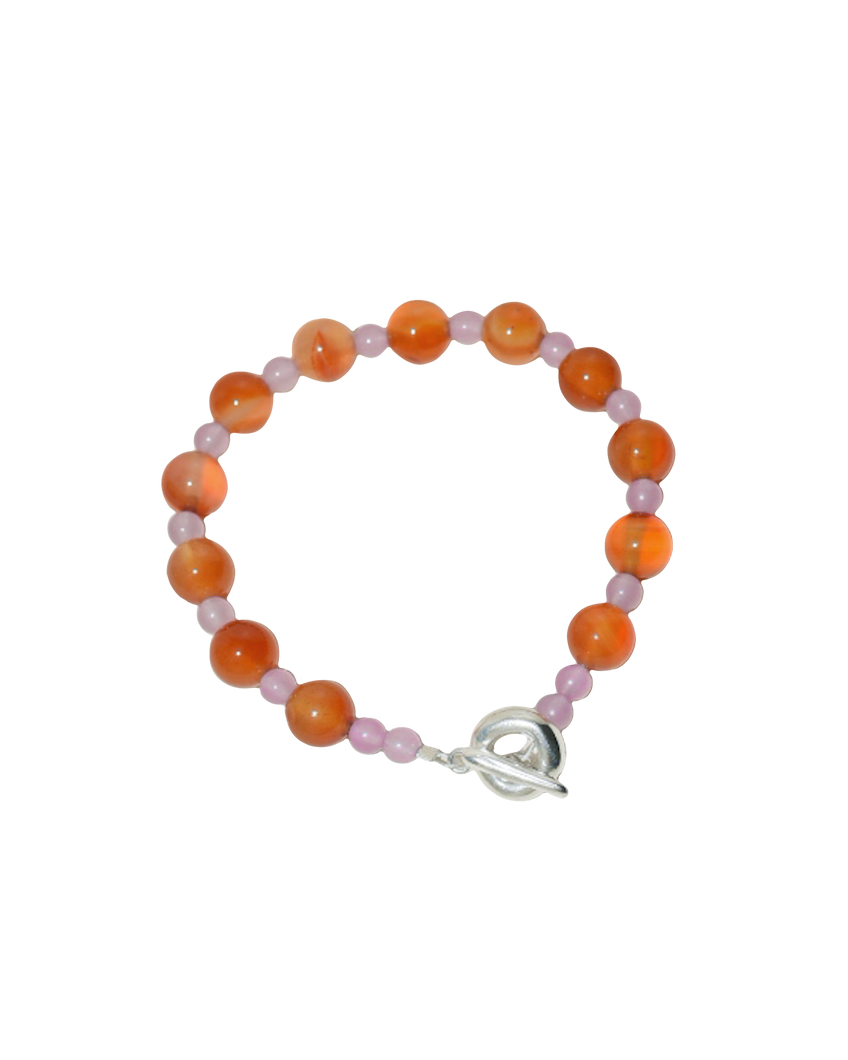 beaded bracelet made of colourful stones and solid recycled silver doughnut toggle clasp. the bracelet is orange and lilac purple with carnelian and lilac dyed jade.