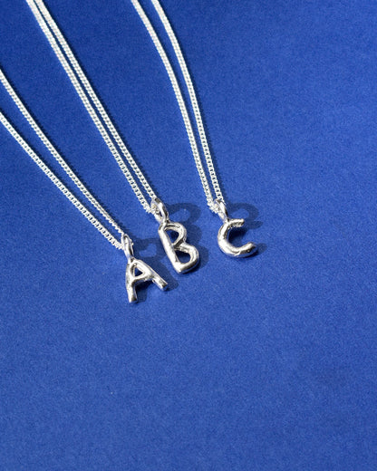 recycled silver hand moulded wobbly alphabet initial charms with organic texture