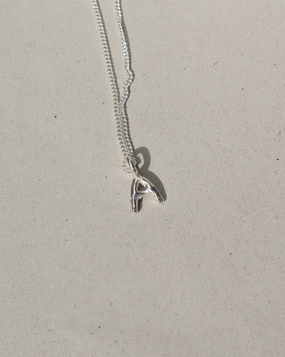 recycled silver hand moulded wobbly alphabet initial charms with organic texture