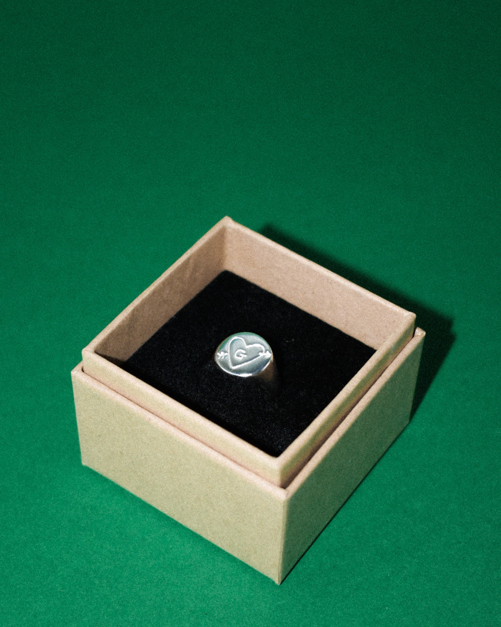 hand carved and personalised solid recycled silver signet ring. etched into with doodle of a heart and arrow and initial. 